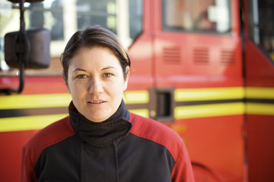 female firefighter in front of appliance