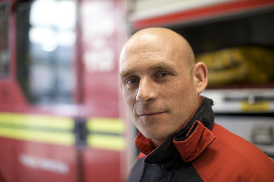 portrait firefighter in front of appliance