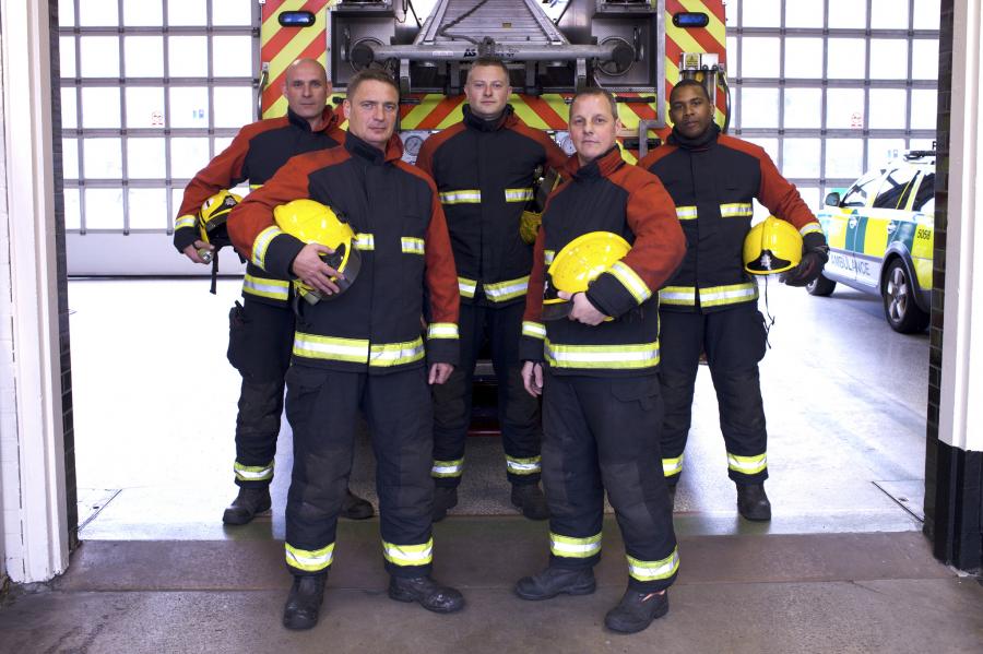 Group firefighters in station in front appliance