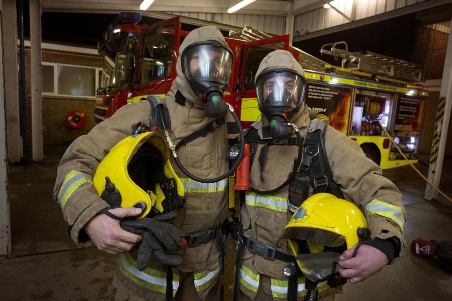 two firefighters in PPE station
