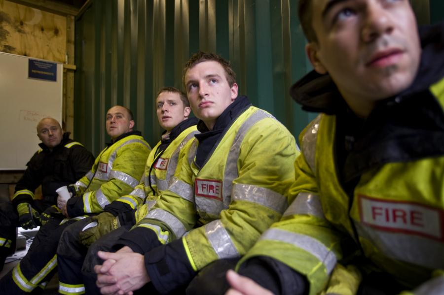 firefighters sitting looking up