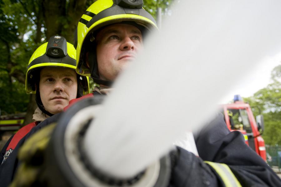 Firefighters close up hose water