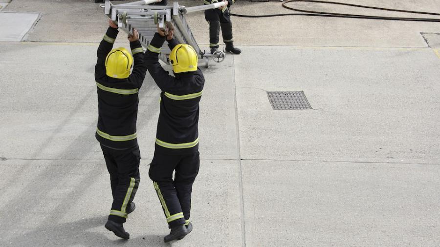 firefighters-raising-ladder