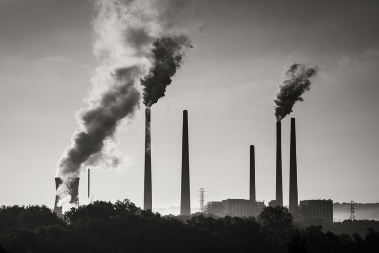 Factory chimneys with emissions coming out of them 