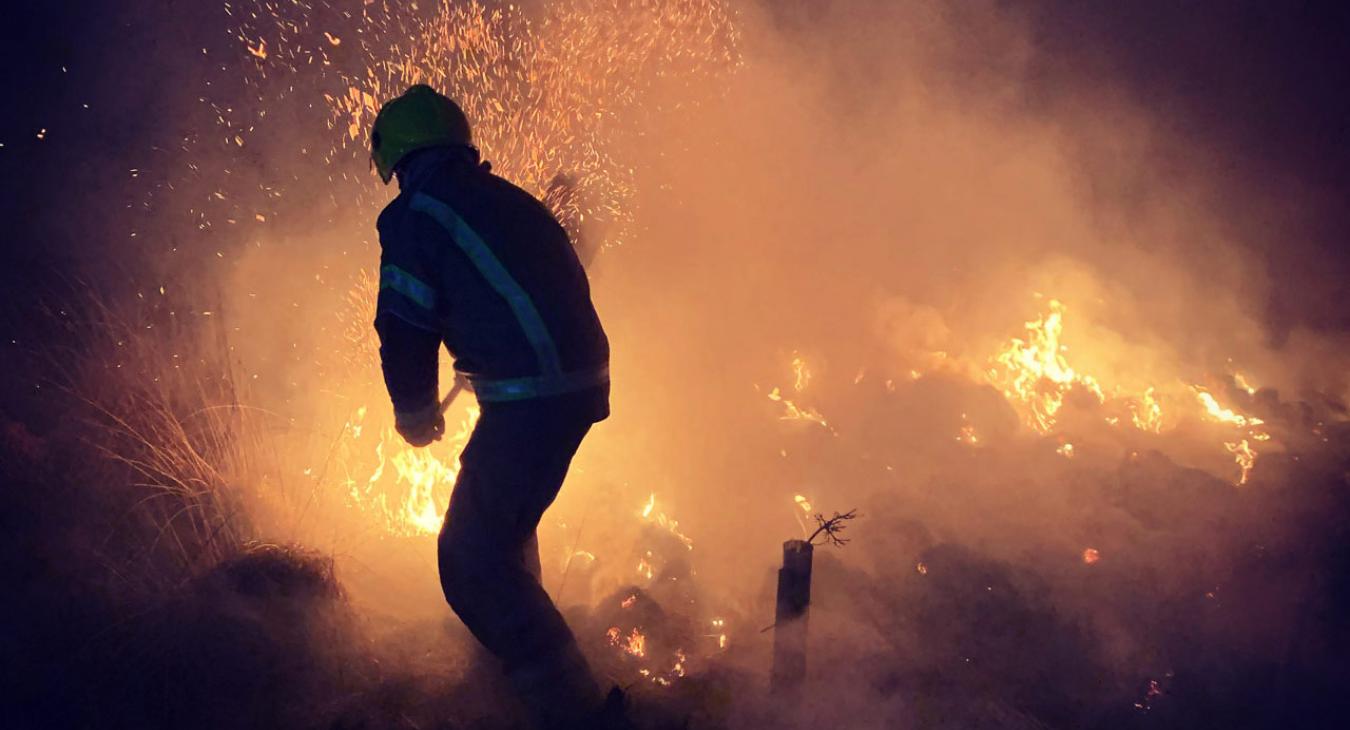 Firefighter fighting outdoors fire