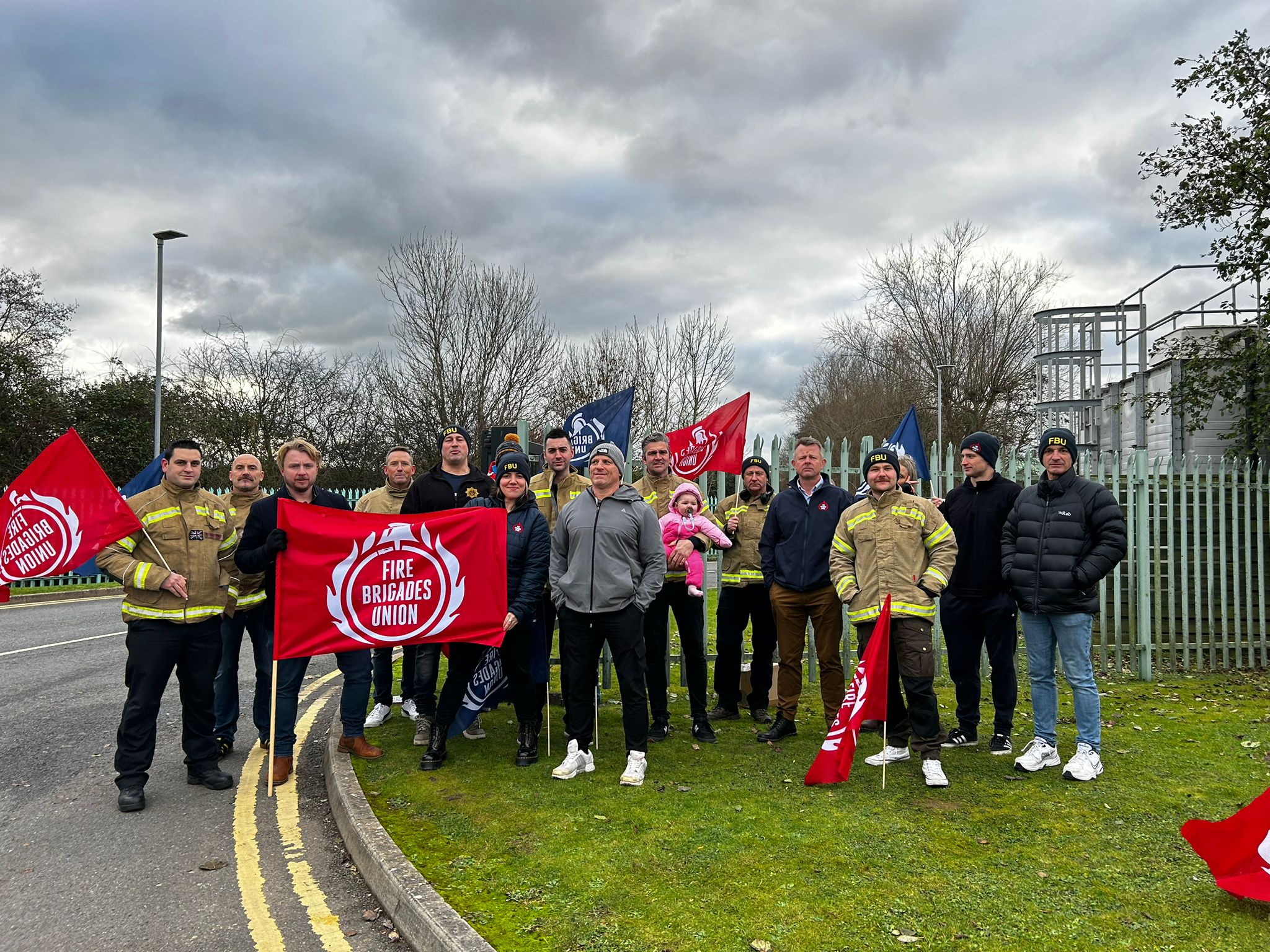 Firefighters gather outside fire authority meeting