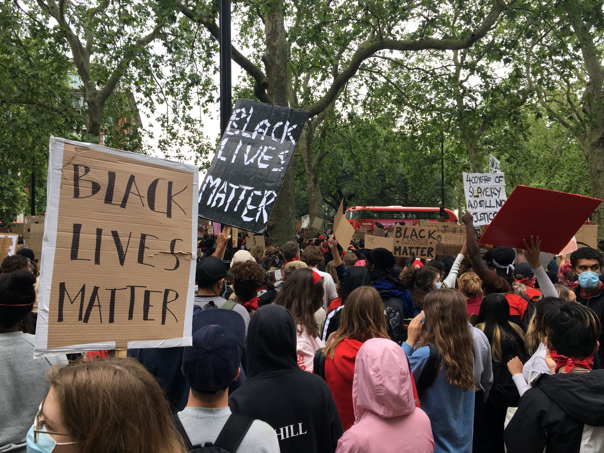 Protestors hold signs that read "Black Lives Matter"
