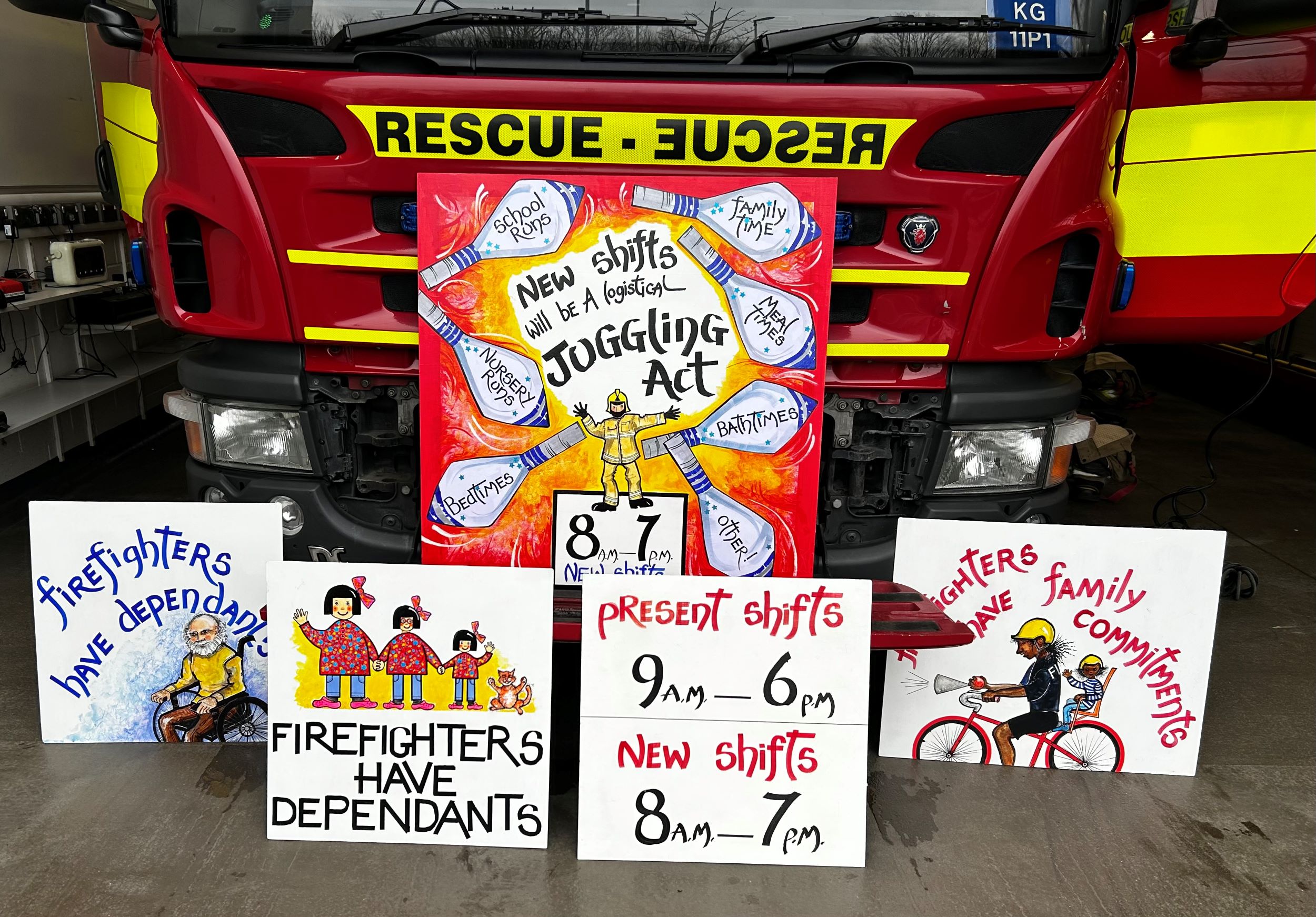 Placards depicting firefighters with children and elderly relatives oppose changes to shifts