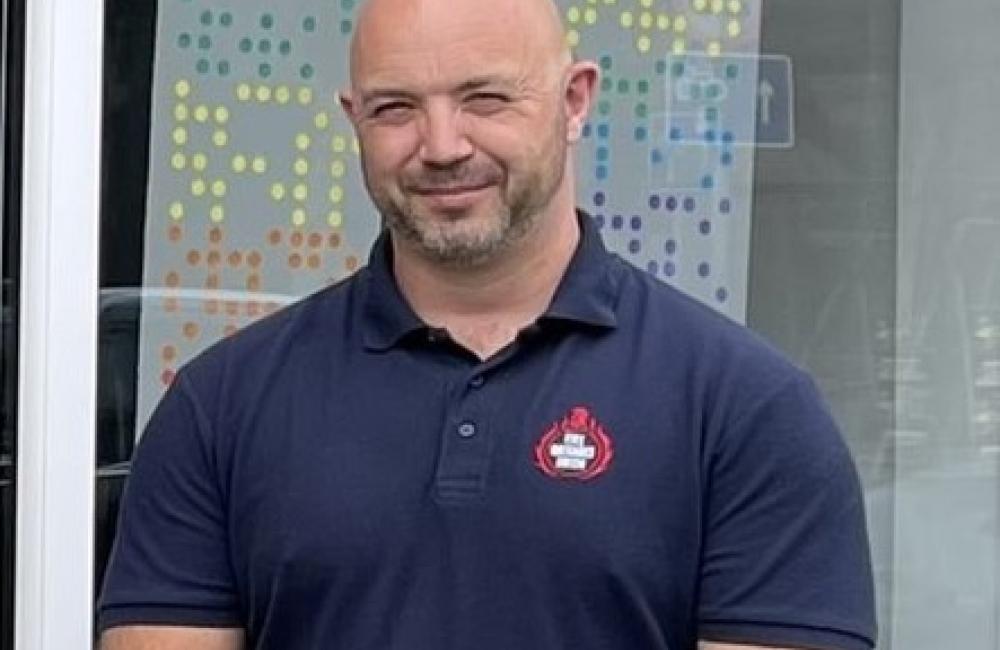 Mark Thomas standing looking at camera in FBU polo shirt