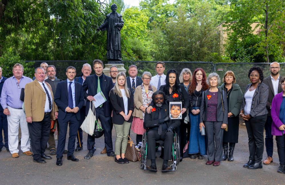 Group photo of campaigners and MPs outside college green