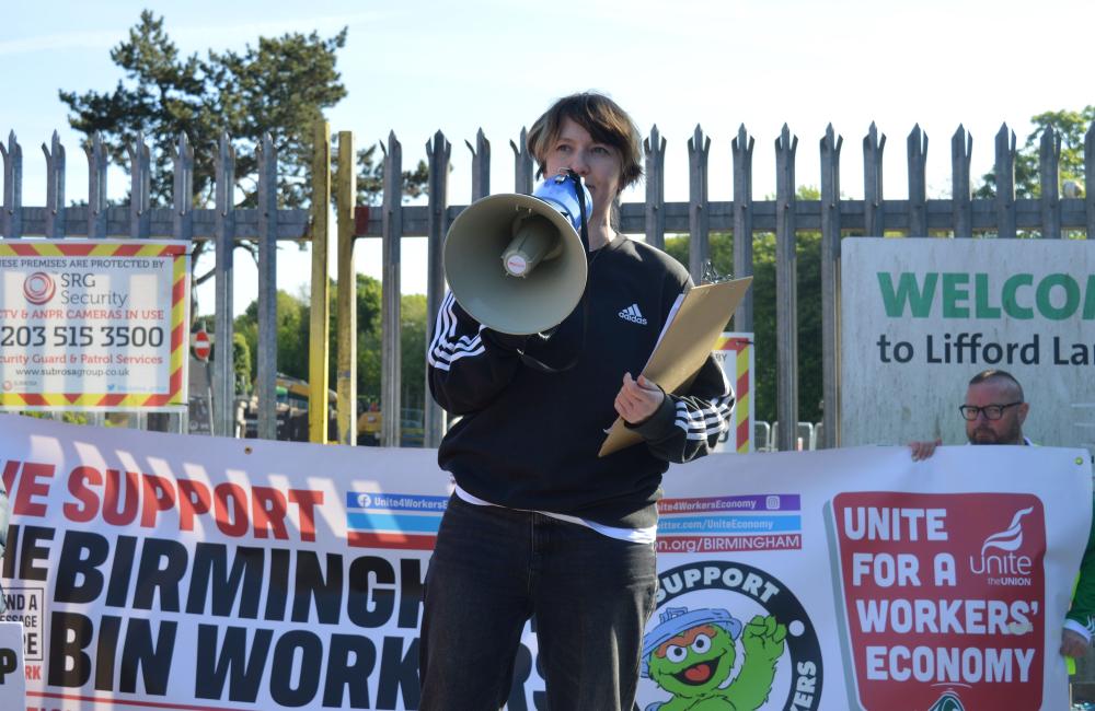 Paula Dunne of Strike Map with a megaphone at the bin strike picket line