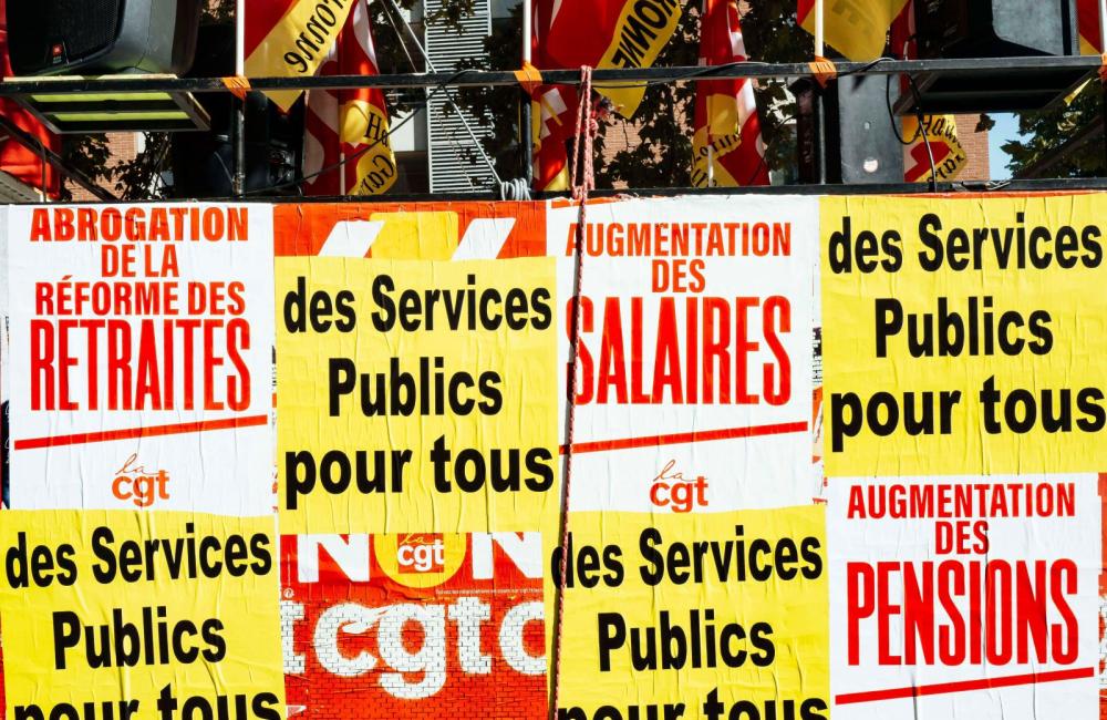A float covered in posters in French at a strike rally