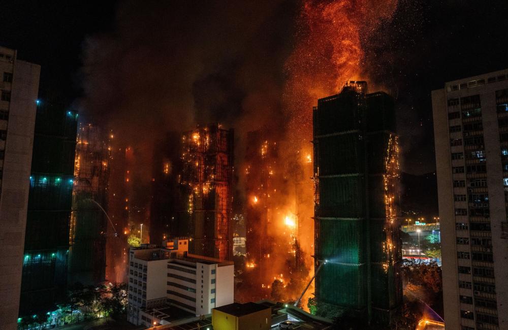 A huge fire rages across multiple apartment blocks
