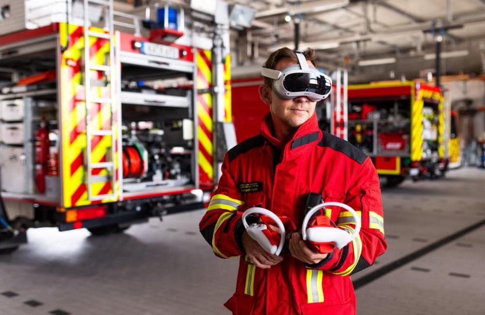 A firefighter in kit at fire station wearing a VR headset