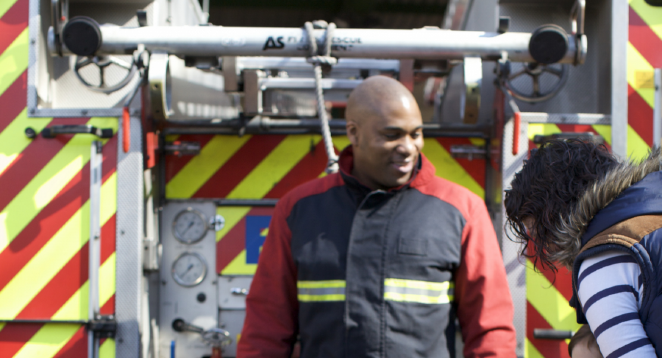 firefighter in front of fire appliance