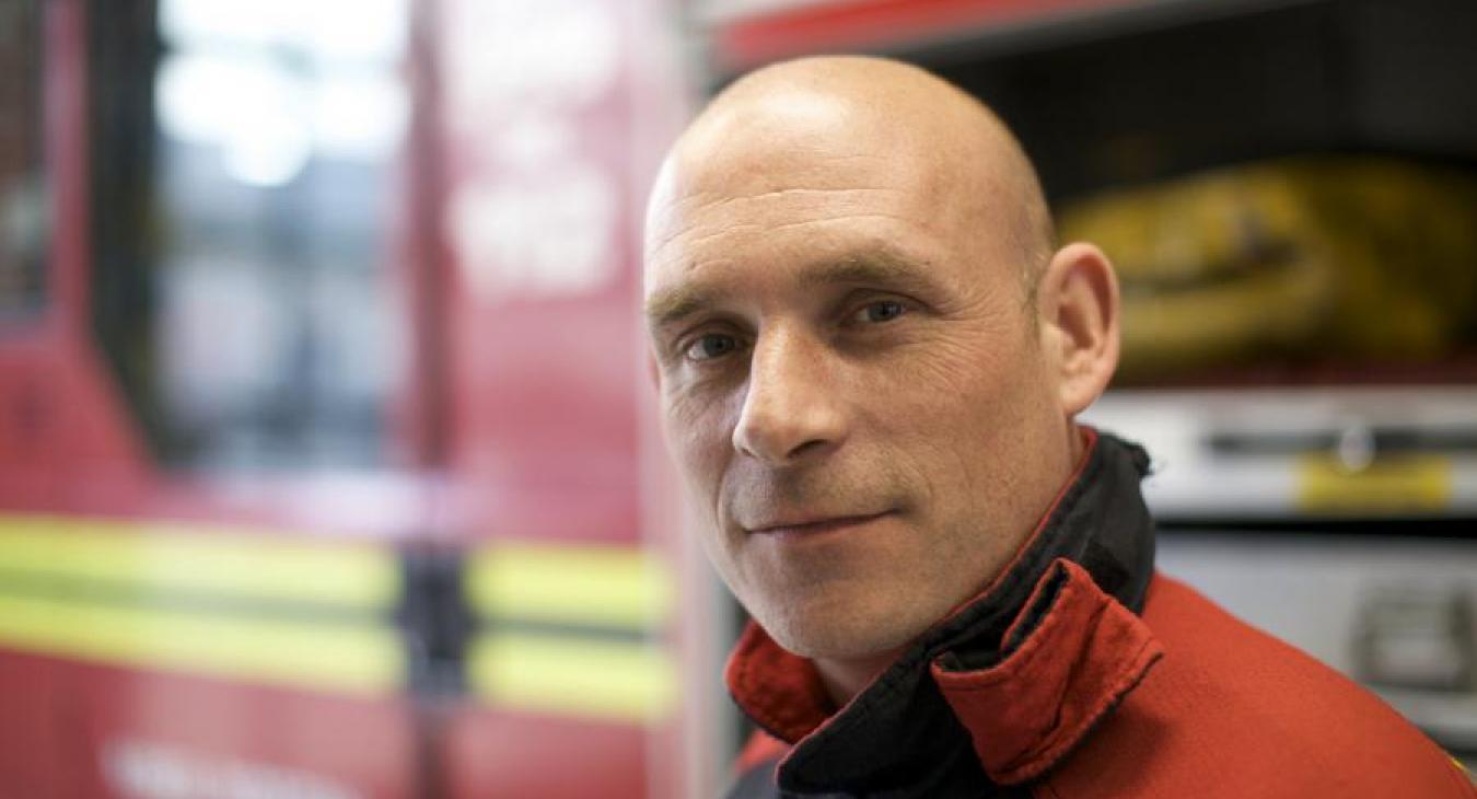 portrait firefighter in front of appliance