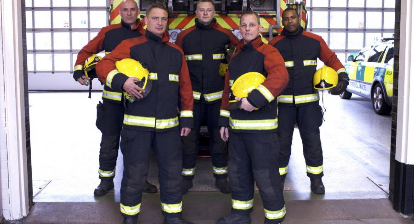 Group firefighters in station in front appliance