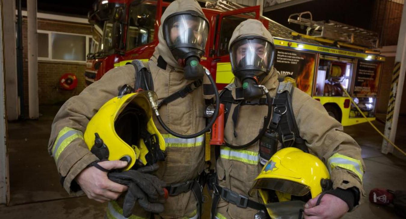 two firefighters in PPE station