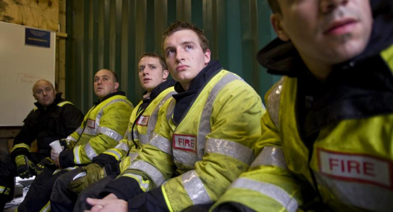 firefighters sitting looking up