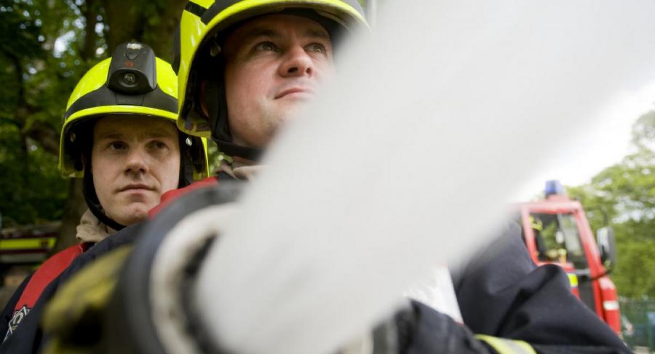 Firefighters close up hose water