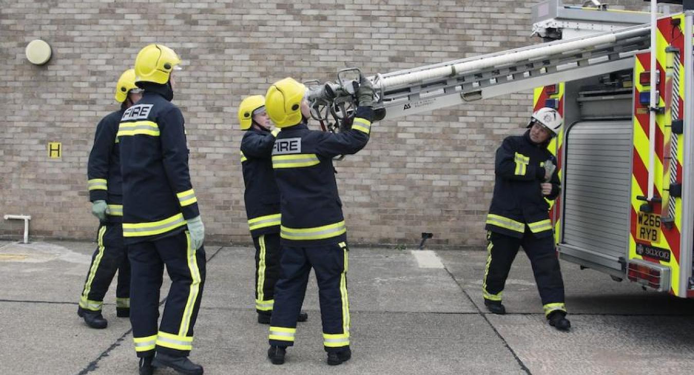 firefighters-putting-ladder-in-engine