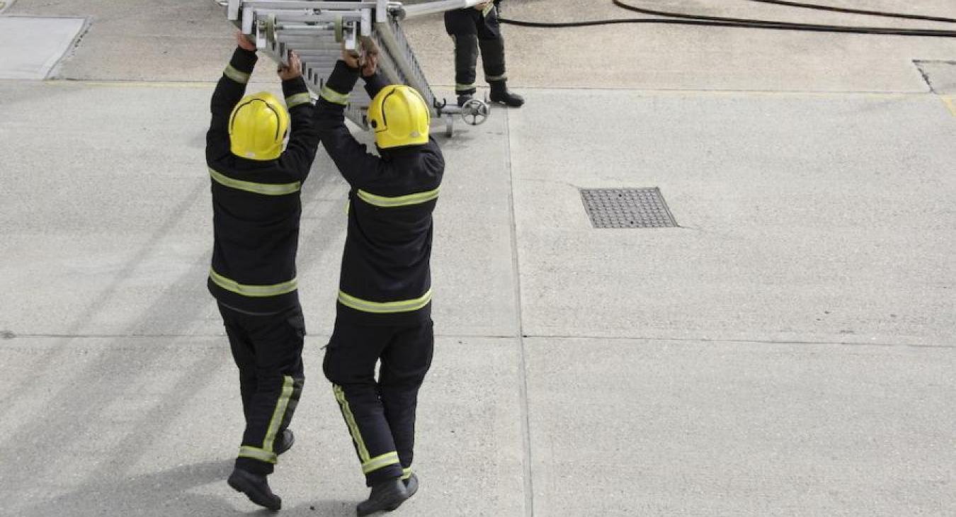 firefighters-raising-ladder