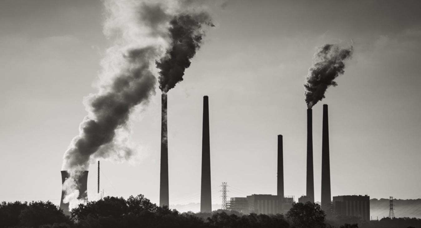 Factory chimneys with emissions coming out of them 