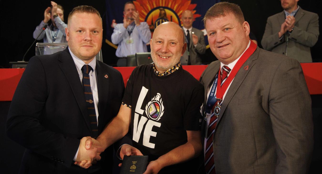 Dave Smith recieves his solidarity medal from Ben Selby and Ian Murray
