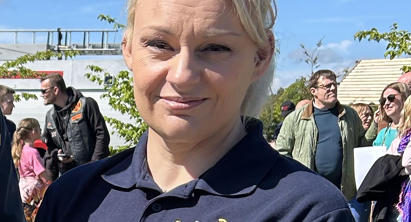 Rebecca Lewington smiling at camera wearing FBU polo shirt