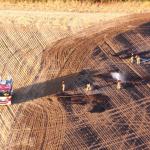 Firefighters manage a field wildfire
